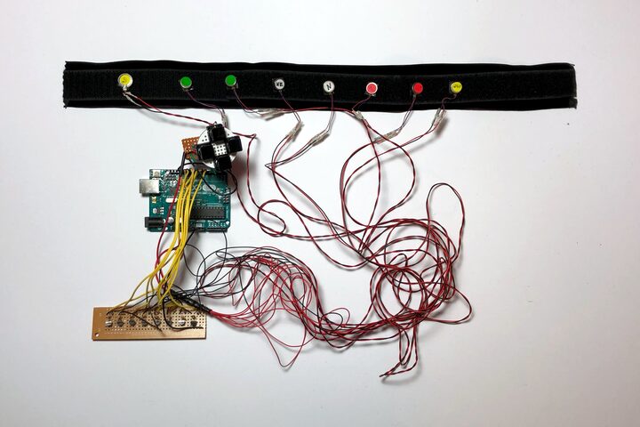 Collar band with vibration motors wired to a microcontroller